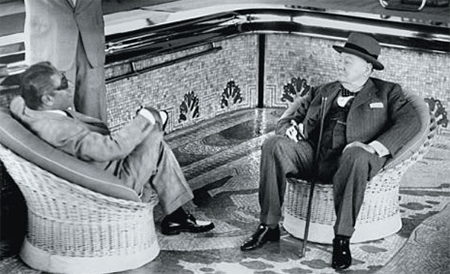 Aristotle Onassis and Winston Churchill seated in an empty pool